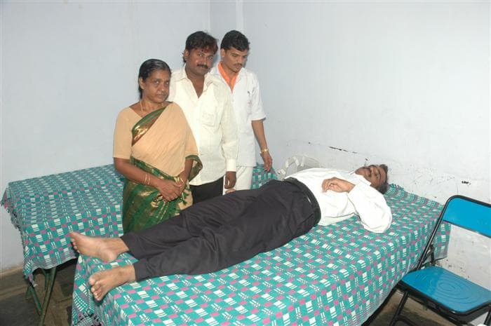 A donor giving blood at a voluntary blood donation camp.